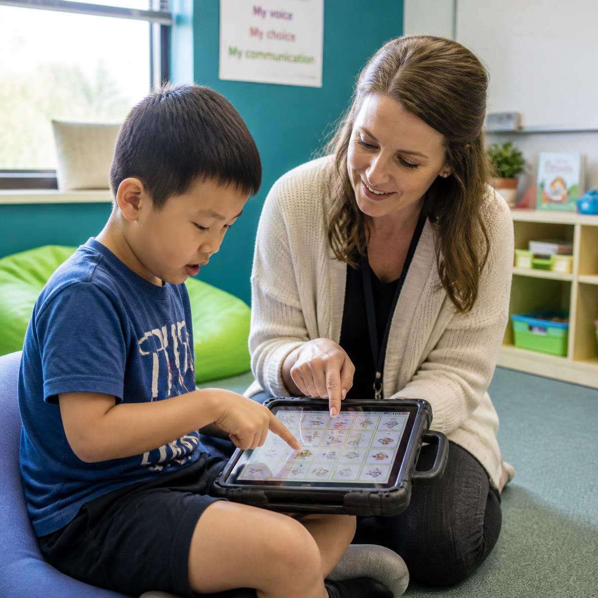 Child using an AAC speech-generating device with a clinician