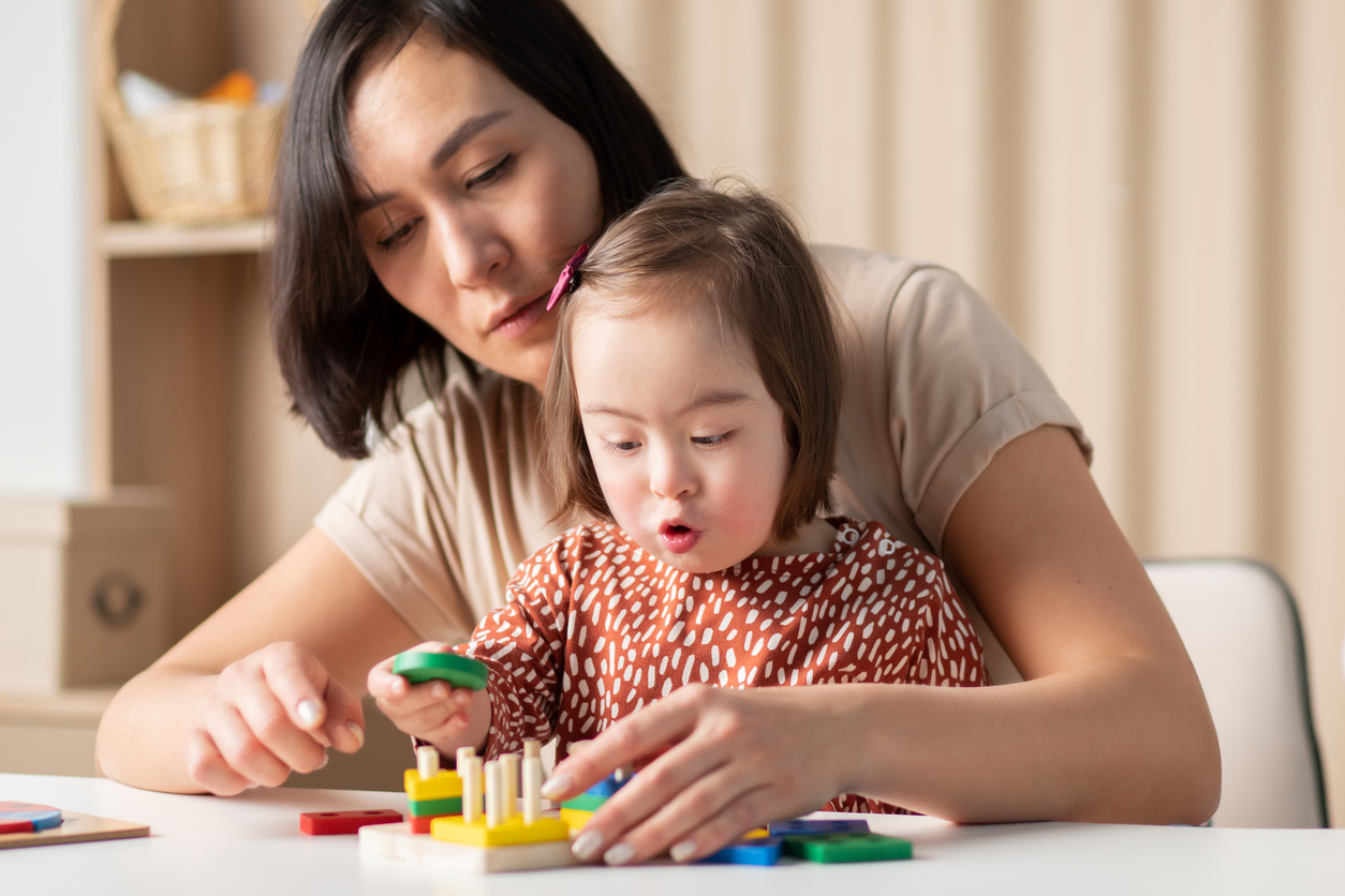 Therapist and child working together on developmental activities